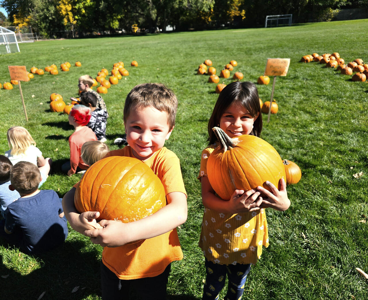1st graders holding up their pumpkins